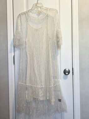 POL White slip like dress with a lacey overlay with sleeves